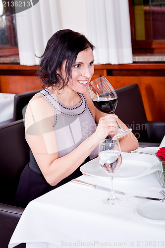 Image of couple drinking red wine in restaurant