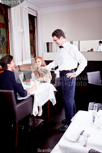 Image of man and woman for dinner in restaurant