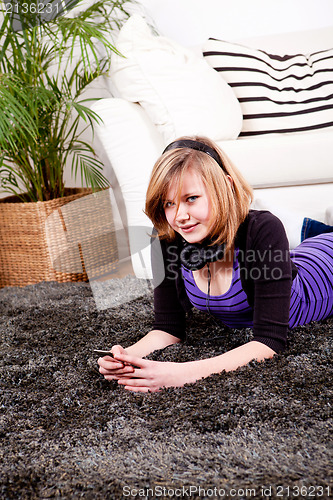 Image of happy teenager girl listening to music