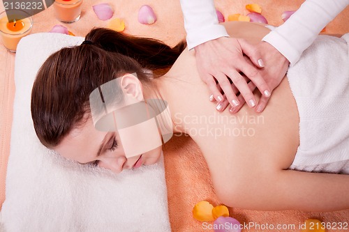 Image of young attractive smilig woman doing wellness spa