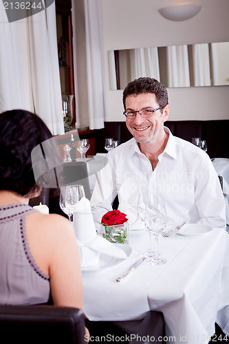 Image of happy smiling couple in restaurant