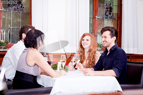 Image of smiling happy people in restaurant