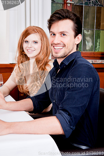 Image of smiling happy people in restaurant