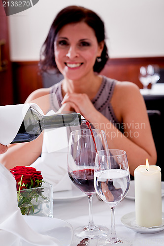 Image of couple drinking red wine in restaurant