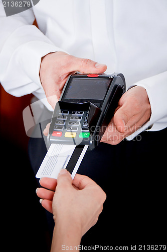 Image of dinner in restaurant man and woman pay by credit card