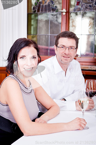 Image of smiling happy people in restaurant