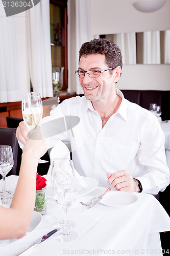 Image of happy smiling couple in restaurant celebrate