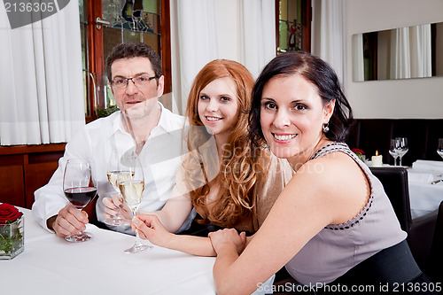 Image of smiling happy people in restaurant