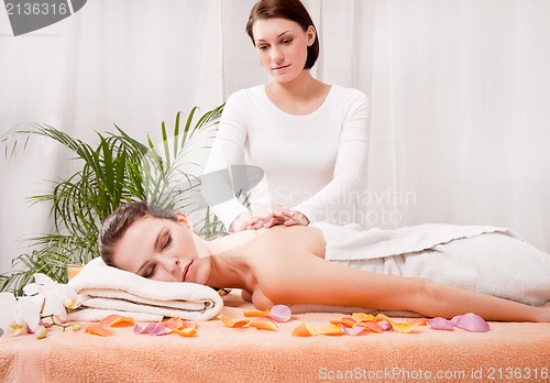 Image of young attractive smilig woman doing wellness spa