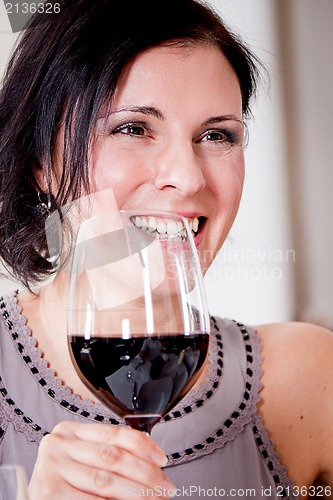 Image of couple drinking red wine in restaurant