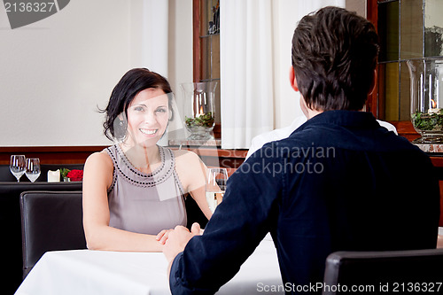 Image of smiling happy people in restaurant