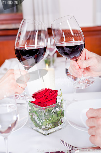 Image of couple drinking red wine in restaurant