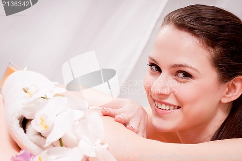 Image of young attractive smilig woman doing wellness spa