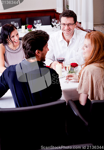 Image of smiling happy people in restaurant