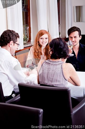 Image of smiling happy people in restaurant