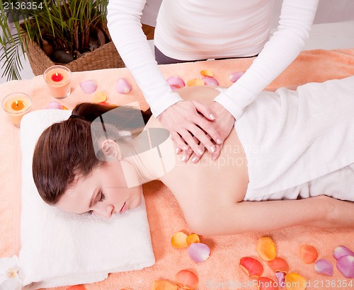 Image of young attractive smilig woman doing wellness spa