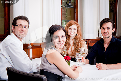 Image of smiling happy people in restaurant