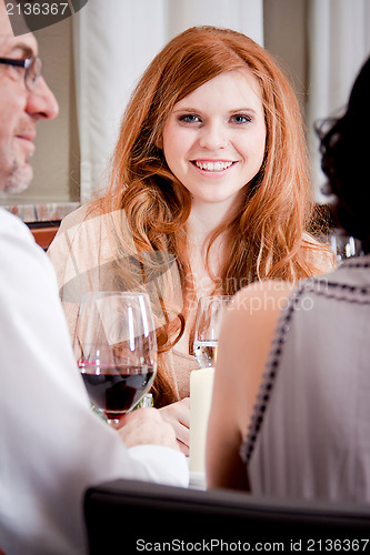 Image of smiling happy people in restaurant