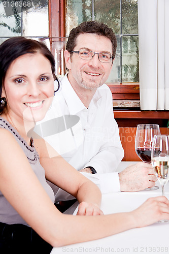 Image of smiling happy people in restaurant