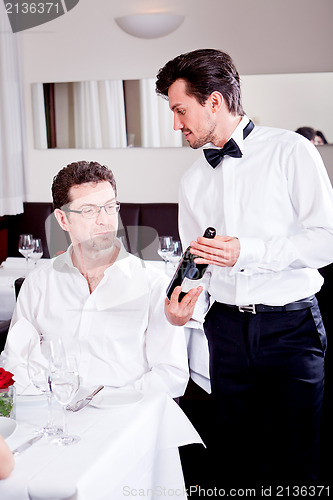 Image of couple drinking red wine in restaurant