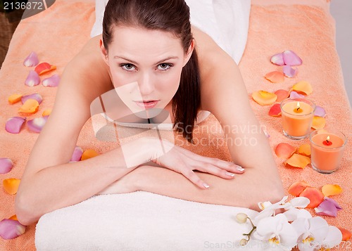 Image of young attractive smilig woman doing wellness spa