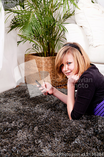 Image of happy teenager girl listening to music