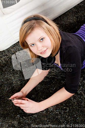 Image of happy teenager girl listening to music