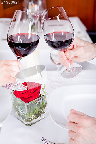 Image of couple drinking red wine in restaurant