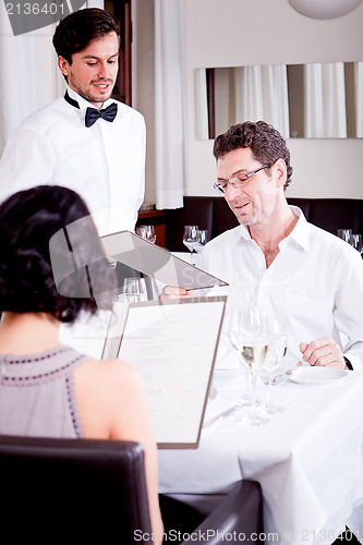 Image of man and woman in restaurant for dinner