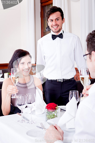 Image of happy smiling couple in restaurant