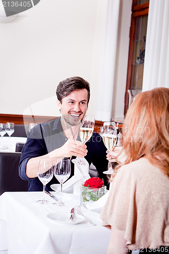 Image of happy smiling couple in restaurant celebrate