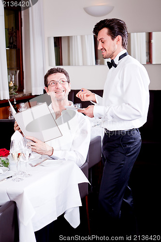 Image of man and woman in restaurant for dinner