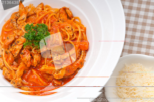 Image of Italian spaghetti pasta with tomato and chicken
