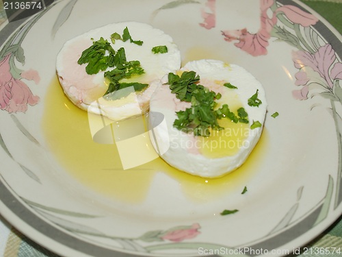 Image of Tomino cheese with rucola and olive oil