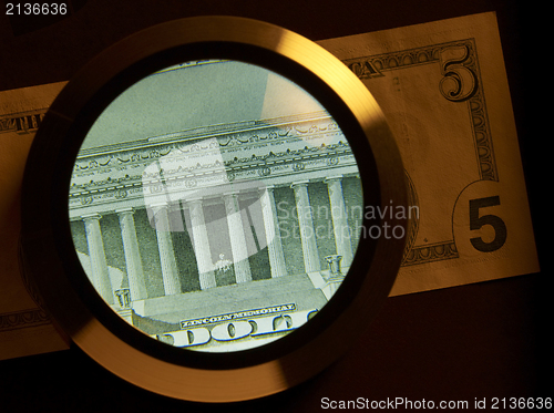 Image of dollar and magnifier
