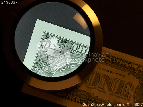 Image of dollar and magnifier