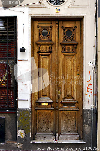 Image of brown wood old door and a grate