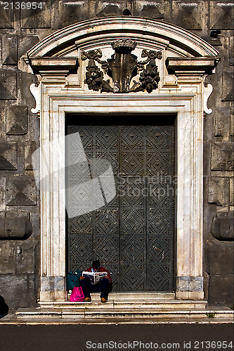 Image of homeless reading a newspaper