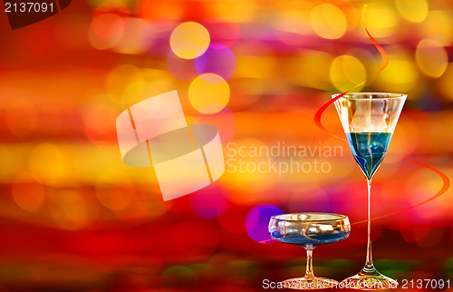 Image of Two blue curacao cocktails and city illumination