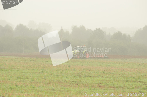 Image of morning agriculture works tractor plow field fog 