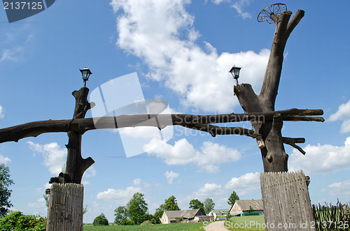 Image of wooden park gate tree trunk rural homestead house 