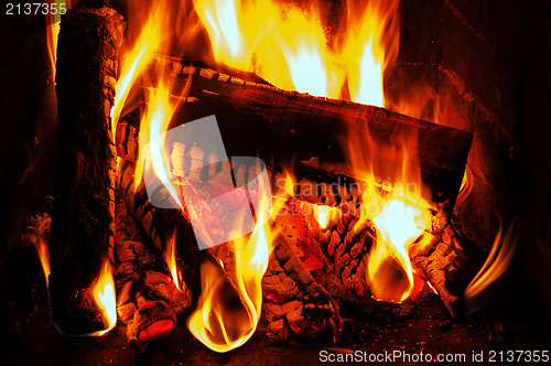 Image of fireplace with oak firewood and flame
