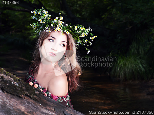 Image of Beautiful girl in national dress and wreath stand in the forest 