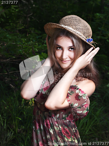 Image of Beautiful girl in the national dress and hat stand in the  fores