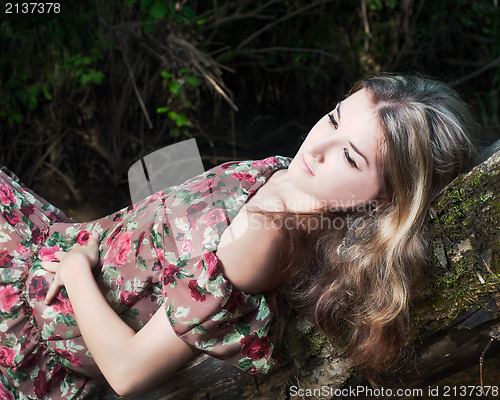 Image of Beautiful girl in the national dress in the forest