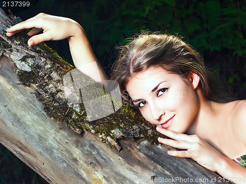 Image of Beautiful girl in the national dress in the forest