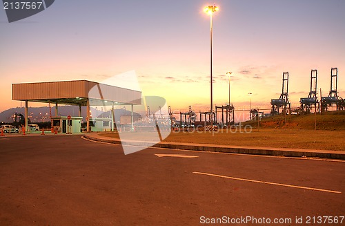 Image of freight ship with working crane at dusk for Logistic Import Expo