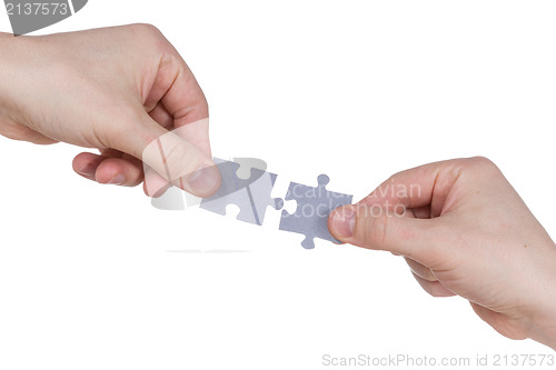 Image of Hands connecting jigsaw puzzle