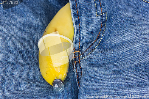 Image of Blue jeans and banana with condom 