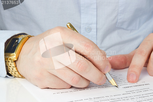 Image of businessman signing agreement